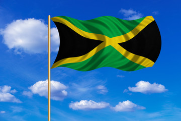 Flag of Jamaica waving on blue sky background