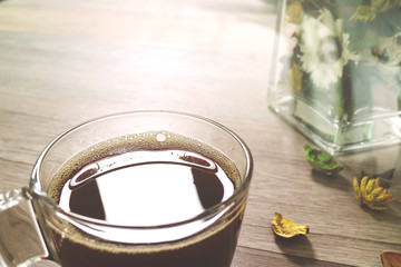 Coffee cup or tea ,glass vase dry flower herbs, on wooden table,