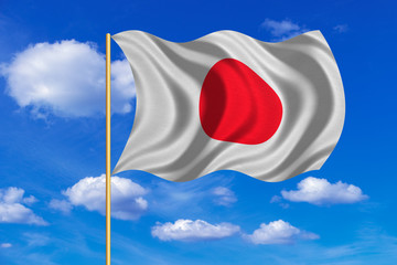 Fototapeta na wymiar Flag of Japan waving on blue sky background