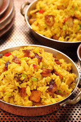 Chicken with basmati rice fried in stainless pan