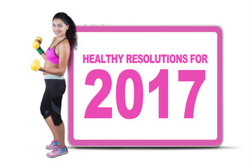 Obraz premium Woman holding dumbbells with a board