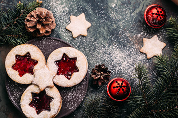 Christmas background - fir tree and holiday cookies with decoration on dark table