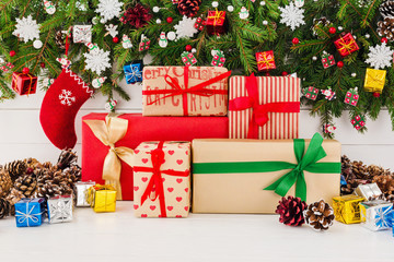 Christmas tree and gift boxes on white wooden background. Copy space 