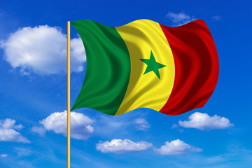 Flag of Senegal waving on blue sky background