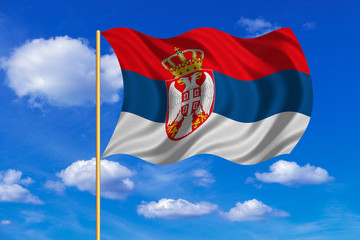 Flag of Serbia waving on blue sky background