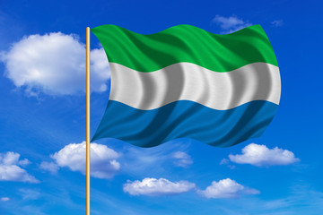 Flag of Sierra Leone waving on blue sky background