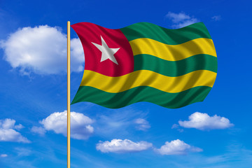 Flag of Togo waving on blue sky background