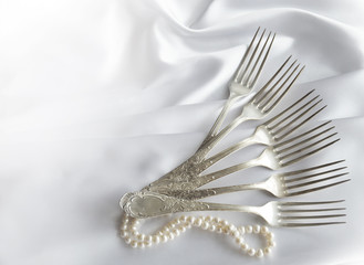 Vintage cutlery on white lace