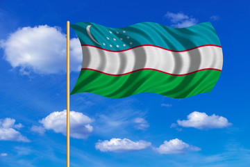 Flag of Uzbekistan waving on blue sky background