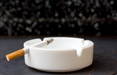 Cigarette in ashtray