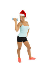 woman in fitness clothes and santa claus Christmas hat holding weight dumbbells