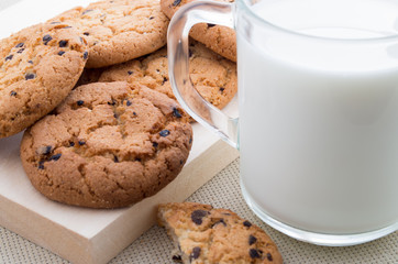 Transparent cup with milk and oatmeal cookies