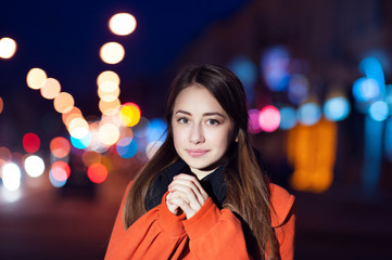 beautiful young woman walking in the night city