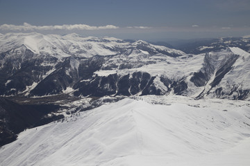 Fototapeta na wymiar Mountain peaks in the snow. View of the mountain on the horizon.