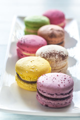 Colorful macarons on the white plate