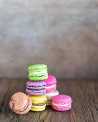 Colorful macarons on the wooden background