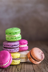 Colorful macarons on the wooden background