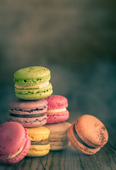 Colorful macarons on the wooden background