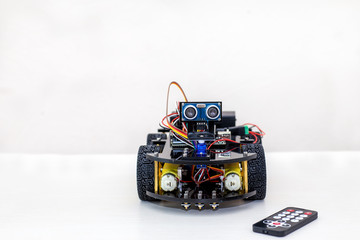 Robot on large wheels stands on a light background