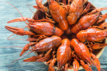 Bowl of boiled crayfish on the wooden table