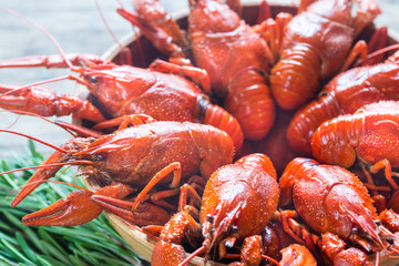 Bowl of boiled crayfish on the wooden table