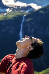 Young man is having fun hiking in Briksdalsbreen, Norway