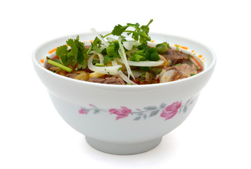 Bun Ho Hue or Vietnamese vermicelli noodles with beef on a white background