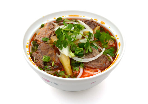 Bun Ho Hue or Vietnamese vermicelli noodles with beef on a white background