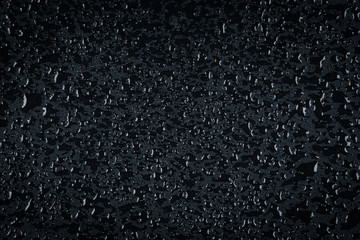 Water drops on dark stone surface