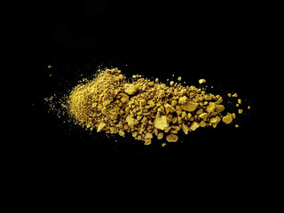 yellow broken and spilled eye shadow on a black background