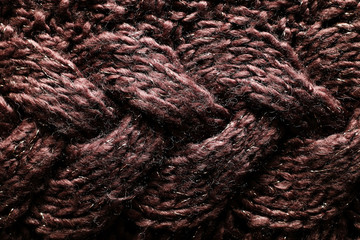 Texture of a dark, warm, winter sweater with unusual patterns.