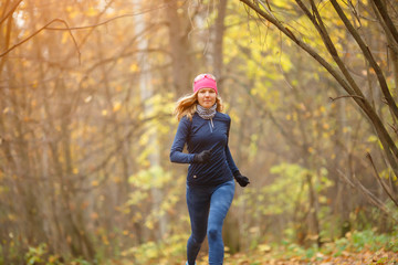 Running on autumn park sportswoman