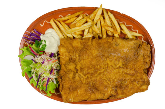 great fried steak with salad and french fries decorated on a cla