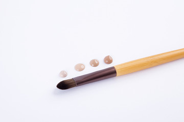 makeup brush and foundation isolated
