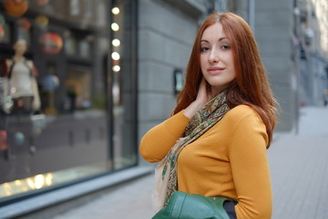 Young Caucasian woman outdoors goes shopping