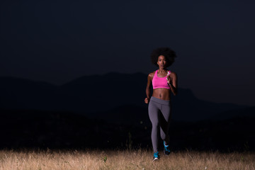 Young African american woman jogging in nature