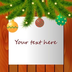 Decorated Christmas tree branches on top of wood background