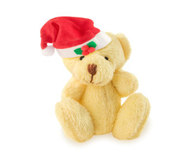 Teddy bear with red Santa hat on white.
