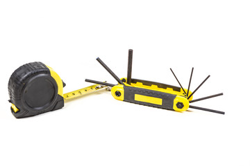 Fototapeta premium Measuring tape and hex wrench set isolated on white background