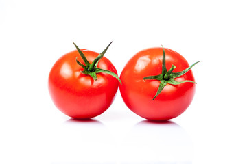 Two tomatoes isolated on a white background