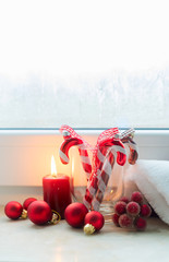 Christmas scene with red burning light on windowsill, vertical shot