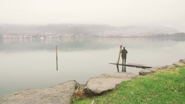 Fisherman catches a fish on the lake
