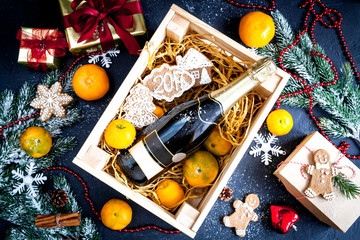 New Year's champagne and tangerines in box top view
