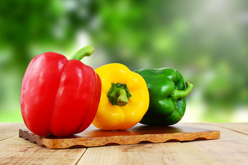 Bell peppers on wooden table.