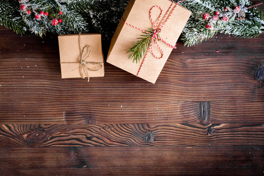 packaging christmas gifts in boxes on wooden background top view