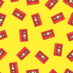 Seamless pattern with red retro audio tape on yellow background.