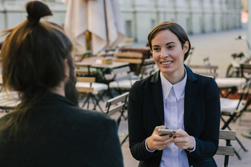 Cheerful young colleagues are working in cooperation