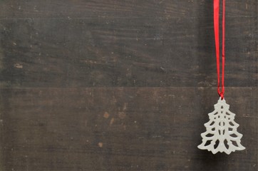 Ivory Christmas tree ornament on wooden background