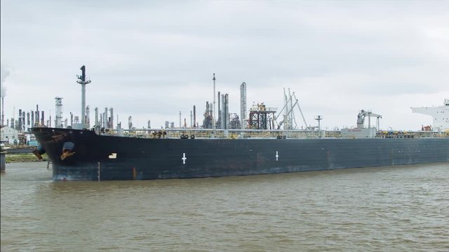 Generic Unmarked Chemical Manufacturing Plant and Freighter Cargo Ship in the Mississippi River