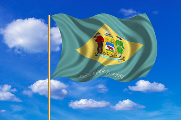 Flag of Delaware waving on blue sky background